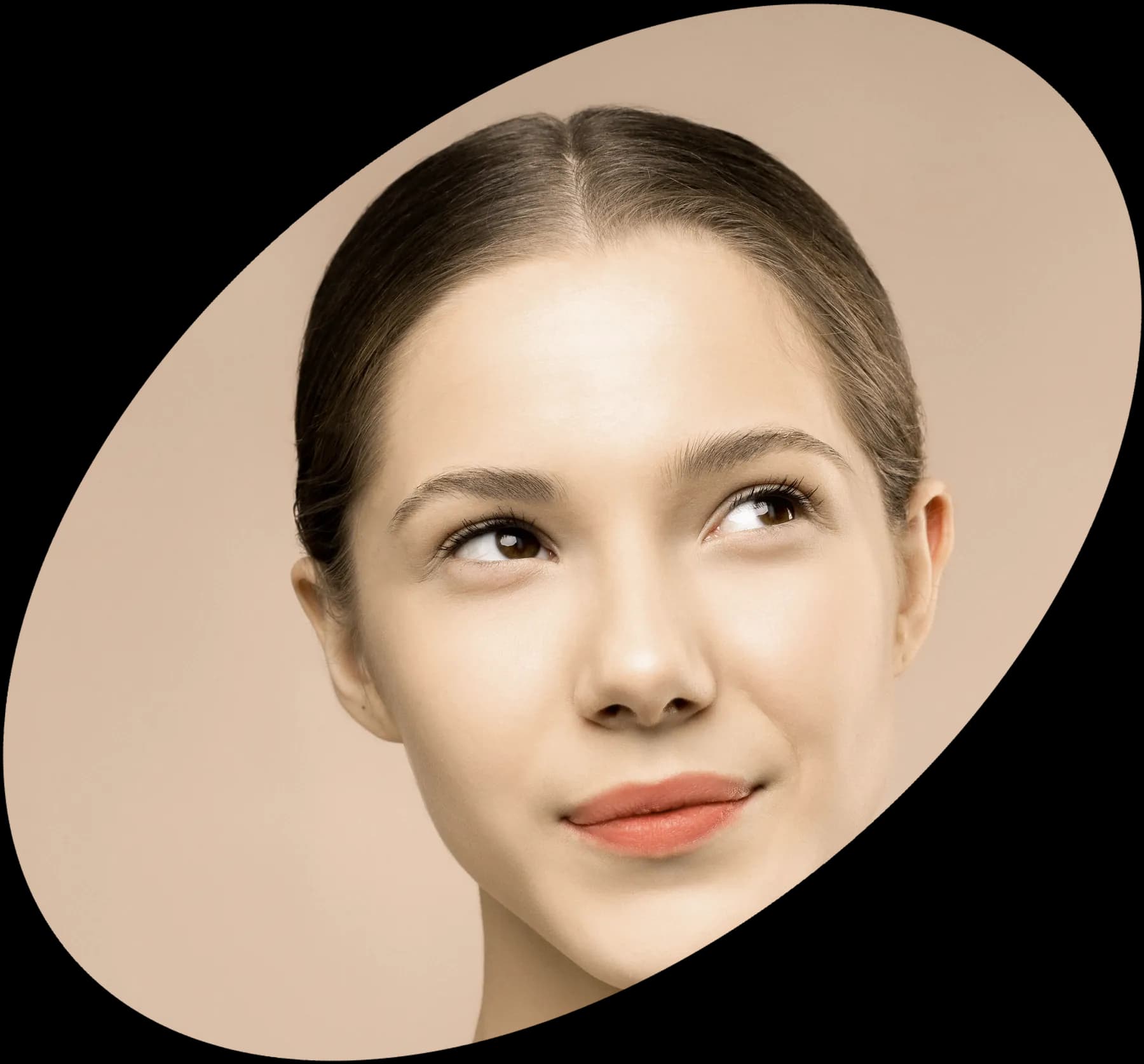 A serene woman in warm light, framed in a tilted oval
