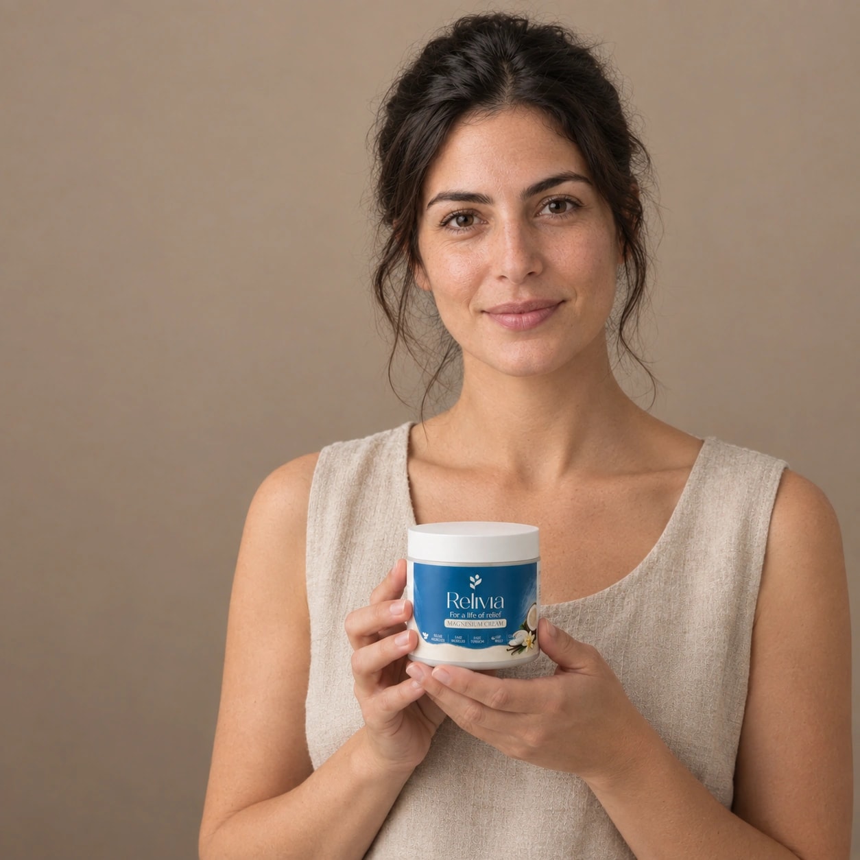 A woman holding the Relivia Magnesium Muscle Relief Cream jar, looking at the camera
