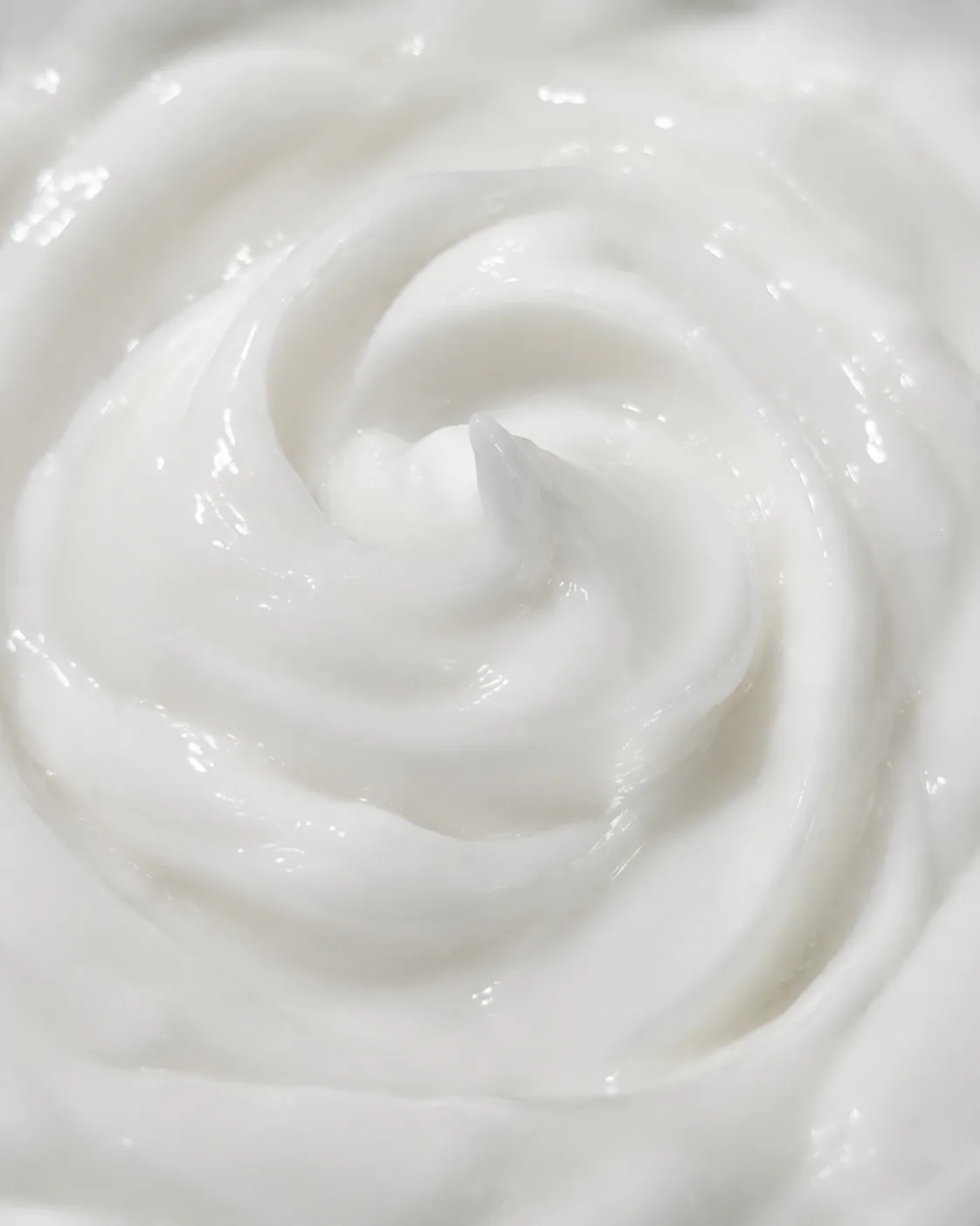 A macro of the cream itself, bright white and freshly swirled